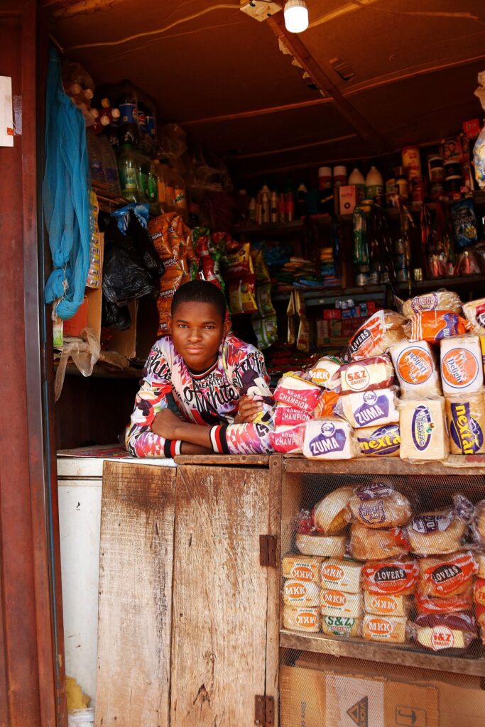 Commerçant dans sa boutique, entouré de ses produits